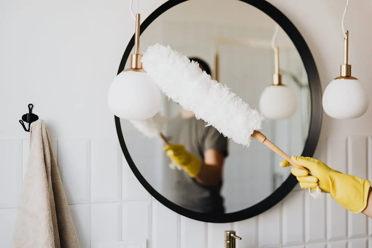 Dusting a bathroom light fixture